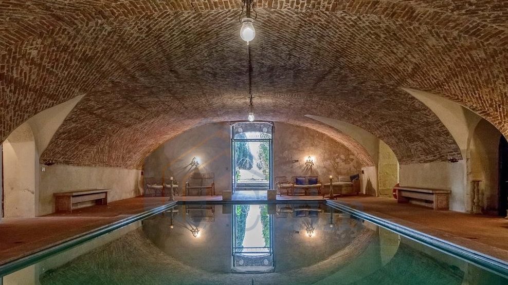 Imressive heated pool featuring vaulted ceilings